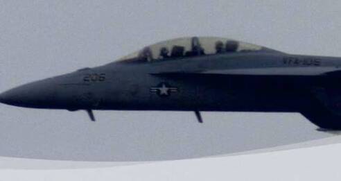A military fighter jet with a gray body and visible cockpit flies against a cloudy sky, showcasing operational excellence. The aircraft has 206 and a star insignia on its side.
