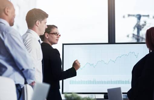 Corporate team discussing private equity playbook during a meeting